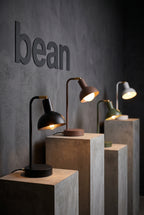 Bean table lamps in all colours on plinths, showroom display
